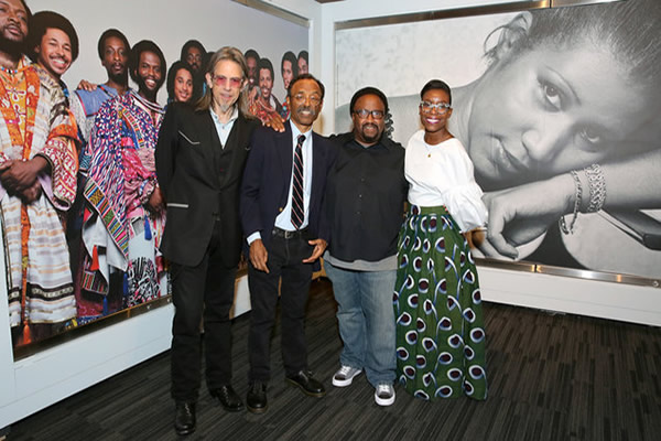 Bruce Talamon, Nwaka Onwusa, and guests inside the exhibition